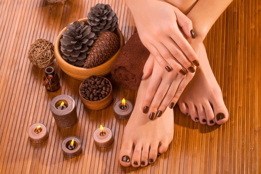 brown manicure and pedicure on the bamboo